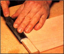 9. Elimine los resaltos que dejan las cuchillas ranuradoras, empujando con gran cuidado el escoplo a través de la espiga. Cuando trabaje, sostenga el escoplo de plano contra el trabajo.